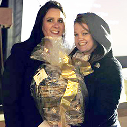 Two military spouses holding a gift bag