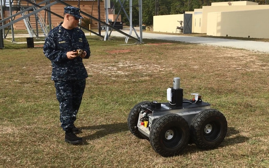 CAMP PENDLETON (November 4, 2014) Lt. Cmdr. Tom McAndrew, assigned to the Office of Naval Research reserve component, operates an unmanned ground vehicle during a demonstration held at Camp Pendleton, California. McAndrew is the recipient of a 2015 Federal 100 award presented to government, industry and academic leaders who have played pivotal roles that affect how the federal government acquires, develops and manages IT. U.S. Navy photo.

