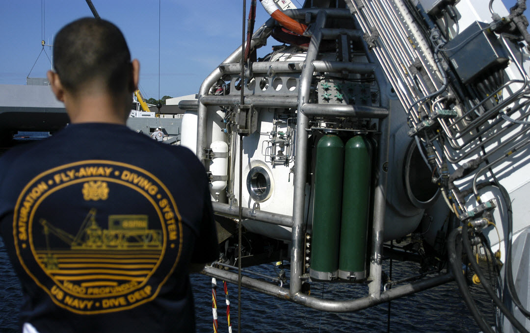 U.S. Navy Diver Chief Allan Manco (DSW/SW) observes the Naval Sea Systems Command (NAVSEA) fly away saturation system, or SATFAD, dive bell moments before pier-side submersion March 10, 2015 during SATFAD training in Panama City, Florida. The training allowed the specialized set of Navy divers to retain qualifications, and hone skills. Manco, who is originally from Vega Alta, Puerto Rico, is assigned to the Naval Reserve Surge Maintenance Dive Unit located in Norfolk, Virginia. Photo by Jacqui Barker/NSWC PCD.