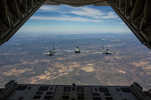 Three Eurofighter Typhoons with the Spanish Air Force escort a U.S. Marine Corps KC-130J Hercules during an aerial refueling mission, Aug. 13, in Spain. Bilateral exercises such as this one are how Spain and the U.S. foster one of the closest defense partnerships around the world. (U.S. Marine Corps photo by Staff Sgt. Vitaliy Rusavskiy/Released)