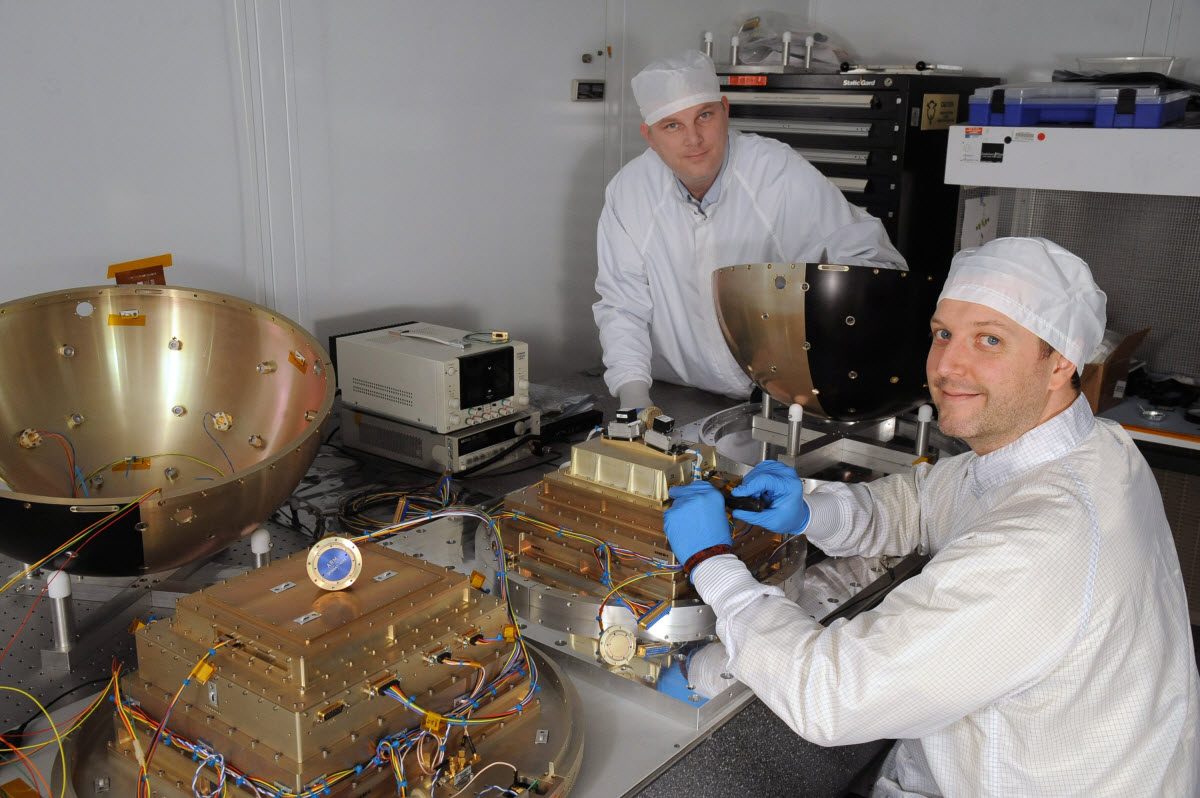 Nicholas (left) and Ted Finne (right) of NRL prepare for the September launch of SpinSat. "It's a multifold mission," says Nicholas, "but the primary mission is demonstration of a new thruster technology." Photo by U.S. Naval Research Laboratory
