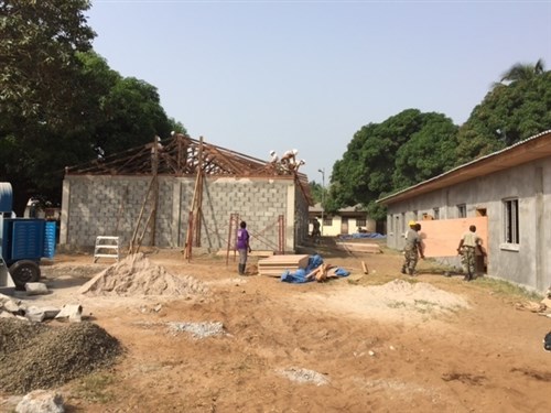 MONROVIA, Liberia - Engineers from the Michigan Army National Guard, 1434th Engineer Company complete a second roof and assist Armed Forces of Liberia members with interior wall construction on two multipurpose buildings, Feb. 3, 2016, at the Edward Binyah Kesselly military training facility in Monrovia, Liberia. The Michigan Soldiers are the last of four Michigan Security Cooperation Opportunity Unit Training rotations that assisted the AFL with the construction of the buildings. Maj. Gen. Gregory Vadnais, adjutant general of the Michigan National Guard traveled to Liberia to cut the ribbon on the buildings and celebrate Liberian Armed Forces Day, Feb. 10, 2016, with the 1434th, AFL leaders and Liberian President Ellen Johnson Sirleaf. (U.S. Army National Guard photo by Maj. David Huber/Released)