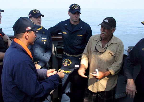 Cmdr. John Barsano, commanding officer of the guided-missile destroyer USS Paul Hamilton (DDG 60), welcomes Ron Ingraham aboard Paul Hamilton. Ingraham was stranded at sea without food or water since Nov. 27. A U.S. Coast Guard cutter later responded to tow the vessel back to port. Joint, interagency and international relationships strengthen U.S. 3rd Fleet's ability to respond to crises and protect the collective maritime interests. Photo courtesy of U.S. Navy.