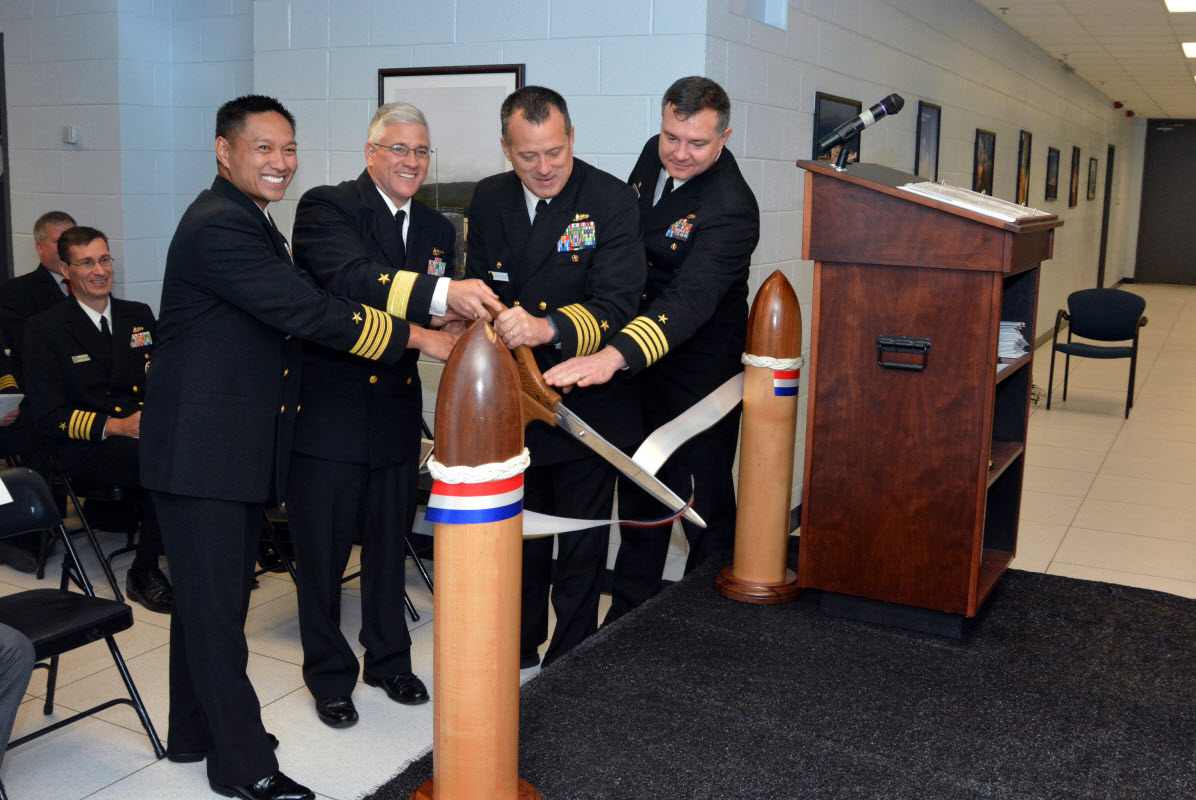 VIRGINIA BEACH, Va. (Nov. 7, 2014) From left, Capt. Leonard Remias, commanding officer of Center for Surface Combat Systems Unit Dam Neck, Rear Admiral Lawrence E. Creevy, deputy commander for surface warfare, Naval Sea Systems Command, Capt. Bill McKinley, commanding officer of Center for Surface Combat Systems and Capt. Jeffrey Sinclair, the program manager for Surface Training Systems Program Office, cut the ceremonial ribbon for the Aegis Ashore Team Trainer at Gallery Hall aboard Dam Neck. U.S. Navy photo by Mass Communication Specialist 2nd Class Alysia R. Hernandez.