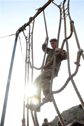 U.S. Army Spc. Steven Saurimayo, 2nd Battalion, 124th Infantry Regiment, climbs a rope obstacle during the French Desert Survival Course May 6, 2016, at Arta Plage, Djibouti. The U.S. forces were required to complete the obstacle course, and then perform the same course in reverse while carrying a tire that could not make contact with the ground. (U.S. Air Force photo by Senior Airman Benjamin Raughton/Released)