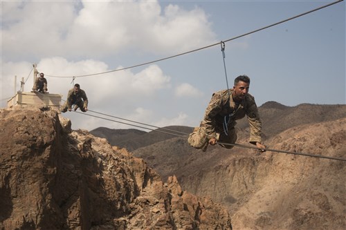 ARTA PLAGE, Djibouti – U.S. Army Soldiers from the 1st Battalion, 124th Infantry Regiment, assigned to Combined Joint Task Force-Horn of Africa, make their way across a portion of the mountain obstacle course, as part of the final day of the French Marines Desert Survival Course, Oct. 10, 2016, at Arta Plage, Djibouti. Approximately 46 U.S. Army Soldiers with French Marines completed several tasks during the survival course, including desert operations, combat lifesaving skills, weapons training, survival cooking, how to decontaminate water, and water and mountain obstacle courses. (U.S. Air Force photo by Staff Sgt. Tiffany DeNault/Released)