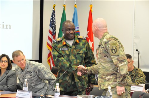 Air Commodore Aminu Yakubu, Nigeria defence attaché is greeted by Maj. Gen. Bryan Watson, AFRICOM director of operations.  The two were participants in a two-day meeting with Gen. Abayomi Olonisakin, Nigeria CDS, and several of his most senior officers and AFRICOM staff and component commanders.  The purpose of the visit was to reinforce the importance of a strong US-Nigeria security cooperation relationship with topics focused on ways to counter terrorism, joint operations, logistics and maritime security in the Gulf of Guinea, Feb. 9, 2016, U.S. Army Garrison Stuttgart, Germany. (Photo by Brenda Law, U.S. Africa Command Public Affairs/RELEASED)