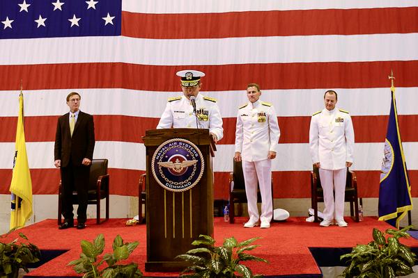 U.S. Navy Vice Adm. David Dunaway gives remarks prior to relinquishing command of the Naval Air Systems Command to Vice Adm. Paul Grosklags, second from right, during a ceremony Friday and Patuxent River Naval Air Station in Patuxent River, Md. Assistant Secretary of the Navy for Research, Development and Acquisition Sean Stackley, left, and Naval Air Forces Commander Vice Adm. Mike Shoemaker, right, congratulated Dunaway on his retirement following 33 years of naval service. Photo courtesy of U.S. Navy.