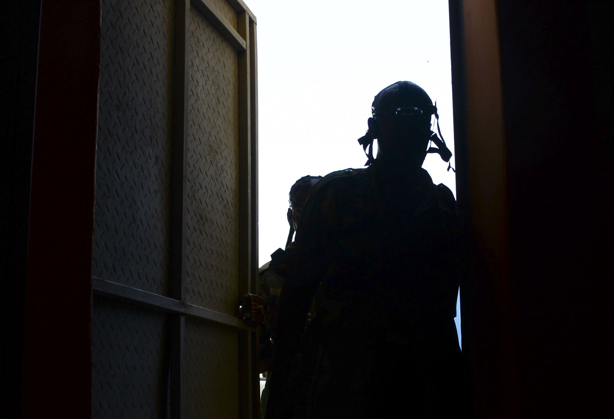 A Djiboutian soldier enters a dark building during a night vision goggle training exercise in Djibouti City, Djibouti, Oct. 10, 2016. During the exercise, the soldiers worked in small teams to navigate obstacles in a dark room to find a designated object and bring it back outside the building. (U.S. Air Force photo by Staff Sgt. Benjamin Raughton)