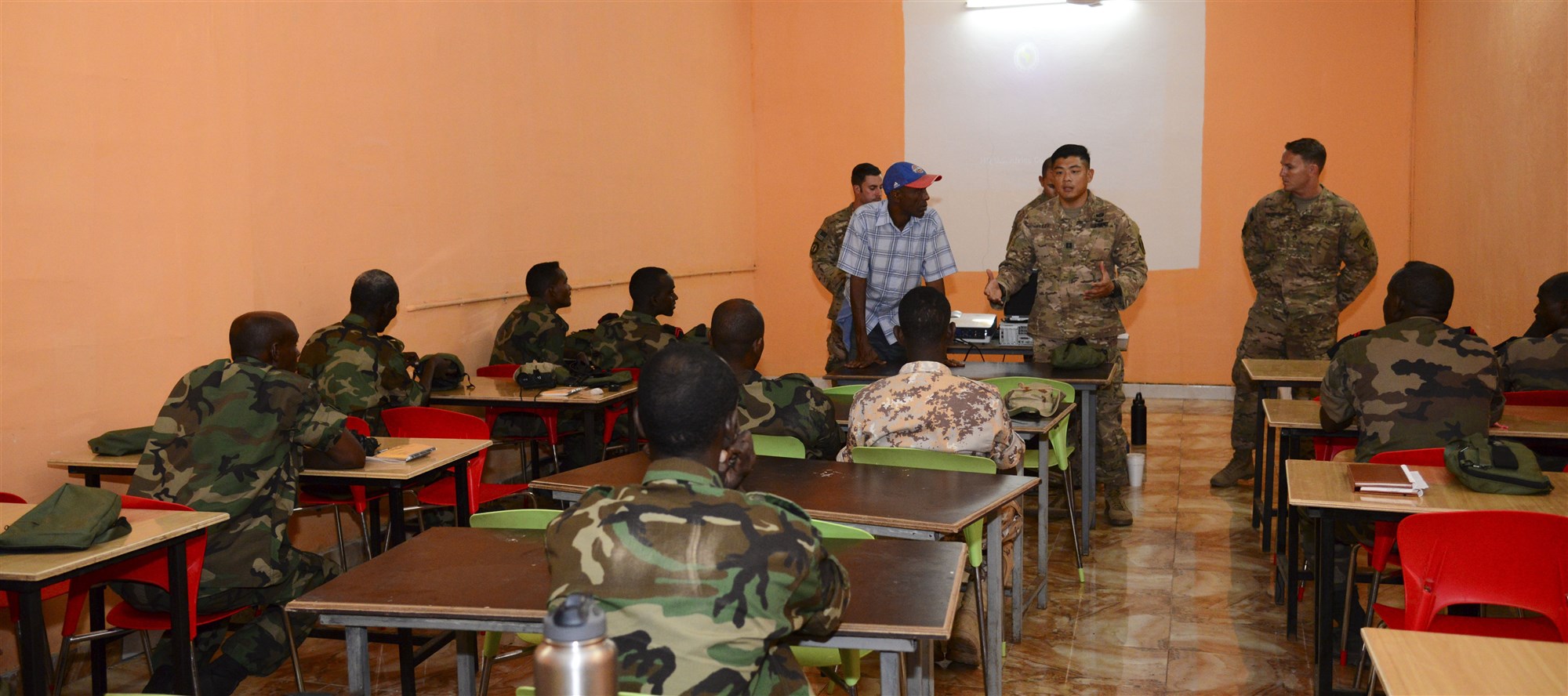 U.S. Army Capt. Samuel Lee, Charlie Company, 411th Civil Affairs Battalion team leader, speaks to Djiboutian soldiers during a night vision goggle training course in Djibouti City, Djibouti, Oct. 10, 2016. The course taught the soldiers the components of an NVG kit, accountability, proper wear, usage and tactics such as signaling teammates.  (U.S. Air Force photo by Staff Sgt. Benjamin Raughton)