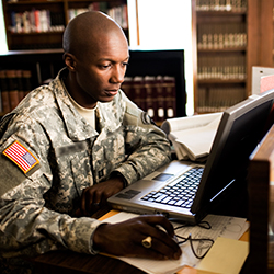 Service member using computer for research