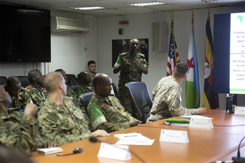 Public Information officers from African Union Mission in Somolia (AMISOM), discuss conference outcomes during the final day of a public information officer seminar June 7, 2014, at Camp Lemonnier, Djibouti. The conference facilitated a forum where AMISOM partnering countries could share perspectives on their operational experiences and also gain knowledge on communications and public affairs.  (U.S. Air Force photo by Staff Sgt. Leslie Keopka)