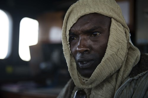 A Djibouti coast guard member role-plays as a pirate during Exercise Cutlass Express 2015 in Djibouti, Jan. 31, 2015. Sponsored by U.S. Africa Command, Exercise Cutlass Express 2015 is designed to improve regional cooperation, maritime domain awareness and information sharing practices to increase capabilities of East African and Indian Ocean nations to counter sea-based illicit activity. (U.S. Air Force photo by Staff Sgt. Carlin Leslie/Released)