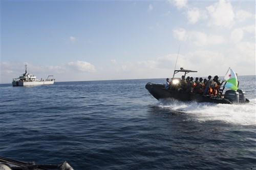 The Djibouti navy and coast guard boarding vessel approaches the target vessel during Exercise Cutlass Express 2015 in Djibouti, Feb. 2, 2015. Sponsored by U.S. Africa Command, Exercise Cutlass Express 2015 is designed to improve regional cooperation, maritime domain awareness and information sharing practices to increase capabilities of East African and Indian Ocean nations to counter sea-based illicit activity. (U.S. Air Force photo by Staff Sgt. Carlin Leslie/Released)