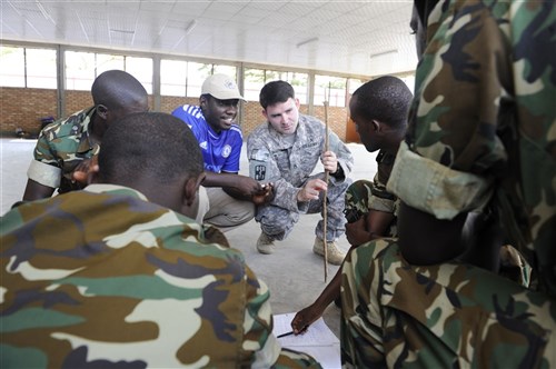 U.S. Army Staff Sgt. Dustin Winkelman, Team 3, Charlie Company, 407th Civil Affairs Battalion medic, forward deployed from Combined Joint Task Force-Horn of Africa, Camp Lemonnier, Djibouti, discusses the PMESII-ASCOPE Crosswalk with a small group of Burundi National Defense Force soldiers at Gukumba Training Area in Bujumbura, Burundi, Sept. 11, 2014. The soldiers participated in the two-week civil military cooperation engagement intended to enhance the understanding of counter insurgency and civil military operations in preparation for their support of the African Union Mission in Somalia (AMISOM). The chart they are creating is a way to assess the operational environment by looking at the political, military, economic, social, information, infrastructure, area, structures, capabilities, organizations, people, and events in a simple visual aide. (U.S. Air Force Photo by Staff Sgt. Jocelyn A. Ford)