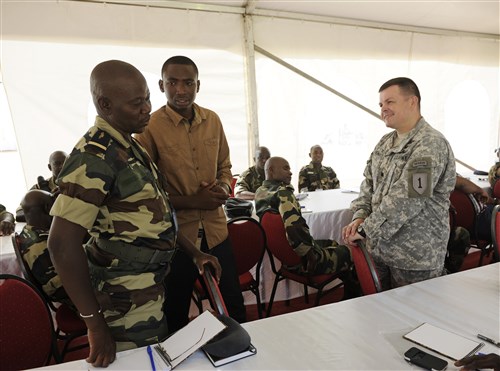 Army Lt. Col. James Tenpenny, U.S. Army Africa mission planner, instructs Airmen from multiple countries during African Partnership Flight in Dakar, Senegal, June 16, 2014. U.S. Air Forces in Europe and Air Forces Africa Airmen are in Senegal for APF, a program designed to improve communication and interoperabilty between regional partners in Africa. The African partners include Senegal, Togo, Burkina Faso, Benin, Ghana, Mauritania, Nigeria and Niger with the U.S. helping with organization. (U.S. Air Force photo by Staff Sgt. Ryan Crane)