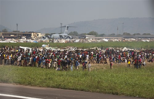 Displaced civilians from Central African Republic, Africa, gather in make-shift living facilities to escape conflict in their home nation Dec. 20, 2013. Airmen of the 37th Airlift Squadron, assigned to Ramstein Air Base, Germany, delivered much-needed supplies and personnel to Central African Republic, Africa, as part of an international peace-keeping mission providing support to the civilian population disrupted by the nation’s recent conflicts. (U.S. Air Force photo/Senior Airman Damon Kasberg)