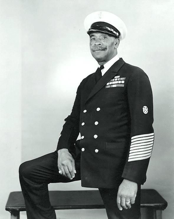 John Henry ("Dick") Turpin, Chief Gunner's Mate, USN (retired) (1876-1962). One of the first African-American Chief Petty Officers in the U.S. Navy. This photograph appears to have been taken during or after World War II. Turpin enlisted in the Navy in 1896. A survivor of the explosions on USS Maine (1898) and USS Bennington (1905), he became a Chief Gunner's Mate in 1917. Transferred to the Fleet Reserve in 1919, CGM Turpin retired in 1925. Qualified as a Master Diver, he was also employed as a Master Rigger at the Puget Sound Navy Yard, and, during the World War II era, made inspirational visits to Navy Training Centers and defense plants. NHHC Photograph Collection, NH 89471.