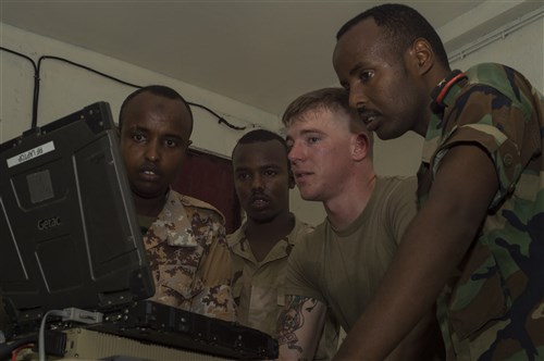 U.S. Army Spc. Dillin Hart, a Combined Joint Task Force-Horn of Africa technician on the Africa Data Sharing Network (ADSN) system, reviews network configurations with members of the Djibouti Armed Forces (FAD) during training validation Sept. 28, 2016, at FAD Headquarters in Djibouti.  While conducting the best practices training, the U.S. Army technicians assigned to Combined Joint Task-Horn of Africa, also held an ADSN validation with the FAD soldiers to prepare them to deploy to Somalia.  The ADSN provides network and Voice over Internet Protocol capabilities between the several African countries participating in the Africa Union Mission in Somalia. (U.S. Air Force photo by Staff Sgt. Eric Summers Jr./Released)