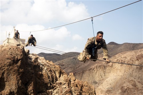 ARTA PLAGE, Djibouti – U.S. Army Soldiers from the 1st Battalion, 124th Infantry Regiment, assigned to Combined Joint Task Force-Horn of Africa, make their way across a portion of the mountain obstacle course, as part of the final day of the French Marines Desert Survival Course, Oct. 10, 2016, at Arta Plage, Djibouti. Approximately 46 U.S. Army Soldiers with French Marines completed several tasks during the survival course, including desert operations, combat lifesaving skills, weapons training, survival cooking, how to decontaminate water, and water and mountain obstacle courses. (U.S. Air Force photo by Staff Sgt. Tiffany DeNault)