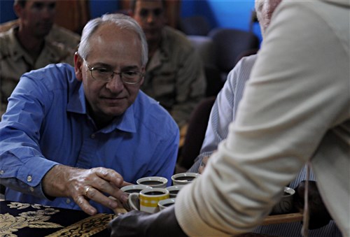 NEGELE BORENA, Ethiopia (Dec. 6, 2011) - The Honorable Donald Booth, U.S. ambassador to Ethiopia, selects a drink from a tray during a coffee ceremony at Negele Borena, Ethiopia, December 6. The ceremony followed the dedication of a bridge built in the town, which provides safe passage for pedestrians and livestock seeking crossing dangerous river. (U.S. Air Force photo by Senior Airman Jarad A. Denton)