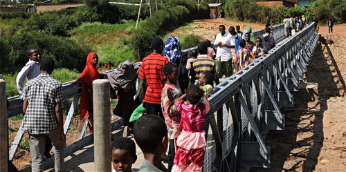 NEGELE BORENA, Ethiopia (Dec. 6, 2011) - Residents of Negele Borena, Ethiopia, line up to cross the recently dedicated town bridge, December 6. The bridge was built as a means for pedestrians and livestock to cross a dangerous river. (U.S. Air Force photo by Senior Airman Jarad A. Denton)