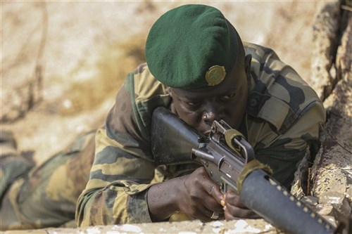 A Compagnie Fusilier de Marin Commando posts security on the beach during the final exercise with U.S. service members in Dakar, Senegal, Sept. 17, 2015. The Marines and Coast Guardsmen with Special-Purpose Marine Air-Ground Task Force Crisis Response-Africa spent four weeks training the COFUMACO on basic infantry tactics and mall-boat operations as a part of a Maritime Security Force Assistance mission to increase interoperability with Senegal’s and strengthen the bond between the partner nations.( U.S. Marine Corps photo by Cpl. Olivia McDonald/Released)