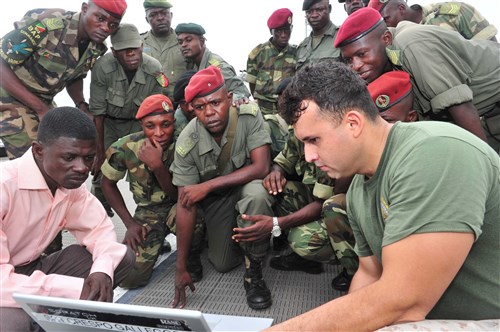 POINTE NOIRE, Republic of Congo - U.S. Marine Sergeant Oscar G. Crespo Gallegos, a non-lethal weapons instructor assigned to Special Purpose Marine Air Ground Task Force (MAGTF) 12.2, Security Cooperation Team 6, shows Congolese service members a security training video aboard High-Speed Vessel Swift (HSV 2), May 17, 2012. Swift is visiting several West African ports as part of Africa Partnership Station (APS) 2012. APS is an international security cooperation initiative aimed at strengthening global maritime partnerships through training and collaborative activities to improve maritime safety and security in Africa. (U.S. Air Force photo by Senior Airman Jonathan Garcia) 