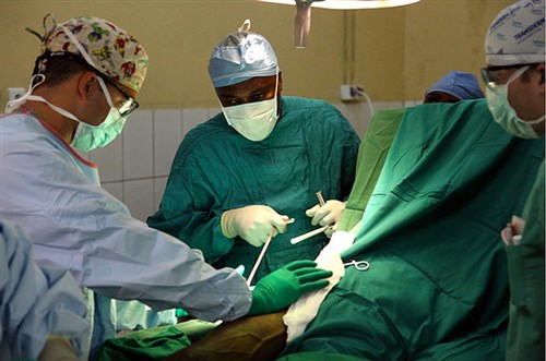 From left) U.S. Army Maj. James Blair, orthopedic trauma surgeon, a Burundi National Defense Force orthopedic surgeon and U.S. Army 1st Lt. James Bills, perform surgery on a patient with a hip fracture at the Kamenge Military Hospital in Bujumbura, Burundi, during the U. S. Africa Command directed, U.S. Army Africa led joint Medical Readiness and Training Exercise 15-1 Jan. 28. Blair, a native of Brooklyn, Conn. and Bills, who calls San Antonio home, are both staff members at William Beaumont Army Medical Center, Fort Bliss, Texas. (U.S. Army Africa photo by Sgt. 1st Class Matthew Chlosta) 