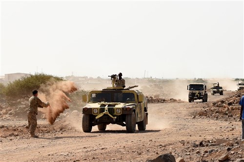 CAMP CHEIK OSMAN, Djibouti – U.S. Army Sgt. Robert Shelton, U.S. Army Regionally Aligned Forces instructor, throws dirt at a Humvee to simulate a roadside detonation causing immobility during Area Logistics Training final with Djiboutian Armed Forces (FAD) soldiers, May 16, 2016, at Camp Cheik Osman, Djibouti. The FAD soldiers tested combat skills they learned throughout the five month course demonstrating their reactions to various mock situations from convoying through a road block, identifying mock roadside bombs, medical care, and vehicle recovery. (U.S. Air Force photo by Staff Sgt. Tiffany DeNault/Released)