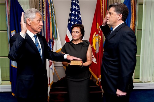 Chuck Hagel is sworn into office as the 24th defense secretary by Michael L. Rhodes, the Defense Department's director of administration and management, as Hagel's wife, Lilibet, holds a Bible at the Pentagon, Feb. 27, 2013. DOD photo by U.S. Navy Petty Officer 1st Class Chad J. McNeeley 