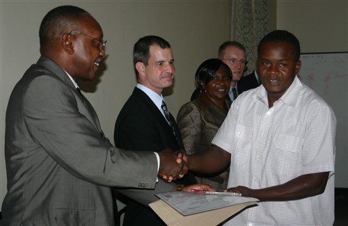 Brig. Gen. Christopher Arrumm (left), Chief of Medical Services, Kenya Defense Forces and Chairman of the East Africa Malaria Task Force presents a certificate of completion to a participant of the malaria diagnostic training recently conducted in Kenya. (Photo courtesy AFRICOM Office of the Command Surgeon)