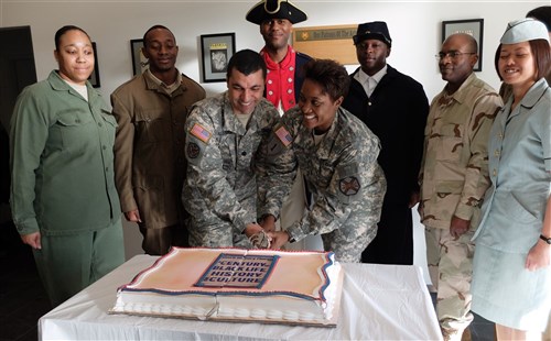 U.S. Army Garrison Command Sgt. Major Lynice Thorpe (right) and AFRICOM Headquarters Commandant, U.S. Army Lt. Col. Troy Alexander, cut the cake. “A Century of Black Life, History and Culture” served as the theme for this year’s Black History Month celebration, held at Kelley Barracks, U.S. Army Garrison Stuttgart, Feb. 26, 2015.  Performances by the Patch High School and Stuttgart Gospel Service Choirs and a dance from the play “Her Stories” highlighted the accomplishments of African Americans over the past century. (U.S. Africa Command photos by Brenda Law/Released)  