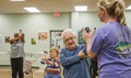 Nicole Sisk, 96th Medical Group clinical health promotion coordinator, helps Frank Acosta with his tricep extension during an exercise session at Eglin Air Force Base, Fla. Go4Life is an eight-week program that builds strength, balance and flexibility. The program also encourages sedentary, older adults to make health improvements by making physical activity a part of their daily routine. (U.S. Air Force photo by Ilka Cole)