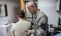 Army Maj. Roger Williams, a flight surgeon from the 2nd Combat Aviation Brigade, listens to his patient's blood circulation with a stethoscope at the Troop Medical Center on Camp Humphreys, South Korea. 