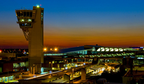 Photo of the Philadelphia International Airport air traffic tower and terminal at dusk
