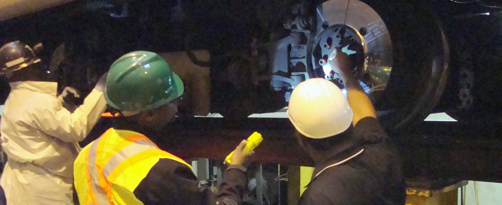 FTA staff and contractors inspect a train car