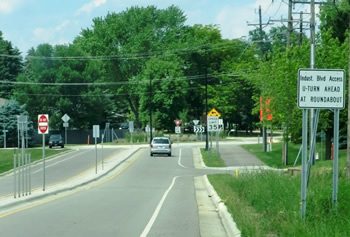 Photo: multilane urban/suburban roadway that accommodates drivers, pedestrians and bicyclists that allows easy entry to and exit from businesses and other destinations.