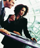 A man and a woman standing at a desk.