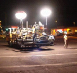 workers on a paving machine