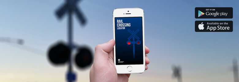 A hand holiding an iPhone with the Grade Crossing Locator Splash screen behind a grade crossing