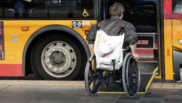 man in wheelchair boarding bus
