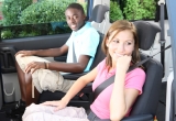 Two teenage children in a vehicle.