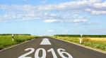 A photo of a road with 2016 painted on it and an arrow pointing towards the horizon.