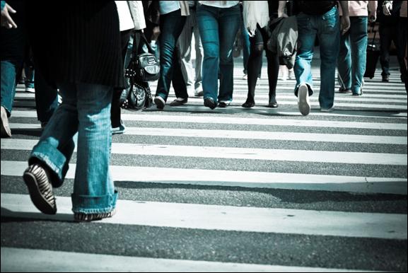 Photo. An image of pedestrians’ feet in a crosswalk.