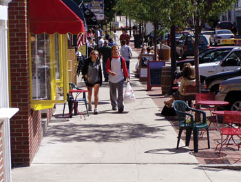 Pedestrians walking on a  sidewalk