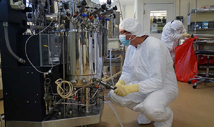 Researchers take a sample from the lab’s fermenter. (Photo by Water Reed Army Institute of Research)