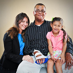 Picture of a wounded warrior with his wife and daughter.