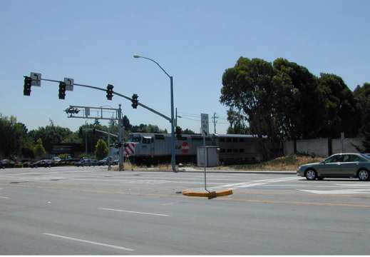 Figure 51. Pre-Signal Located Ahead of Grade Crossing with Displaced Stop Bar, S. Mary and W. Evelyn at Caltrain Commuter Line, Sunnyvale, California. Image of car stopped at railroad crossing with train approaching on track.