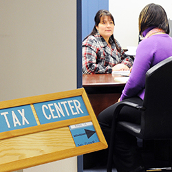 Two women speaking in tax center office